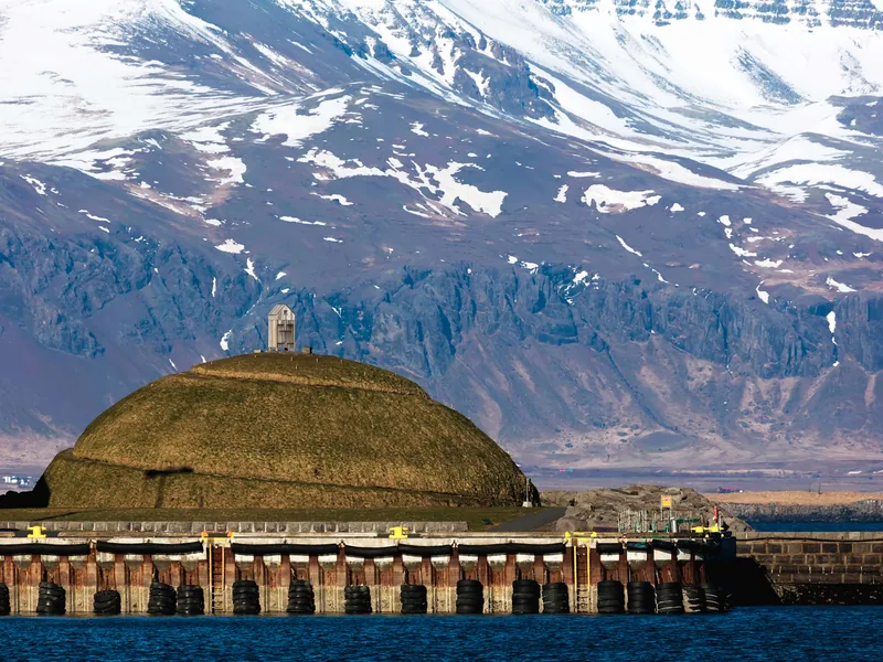 Þúfa, the grass-covered spiral mound with a fish-drying hut on top